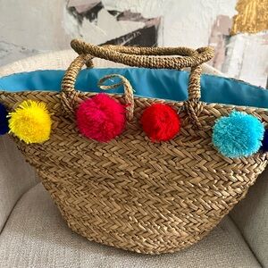 Straw beach bag with pom poms